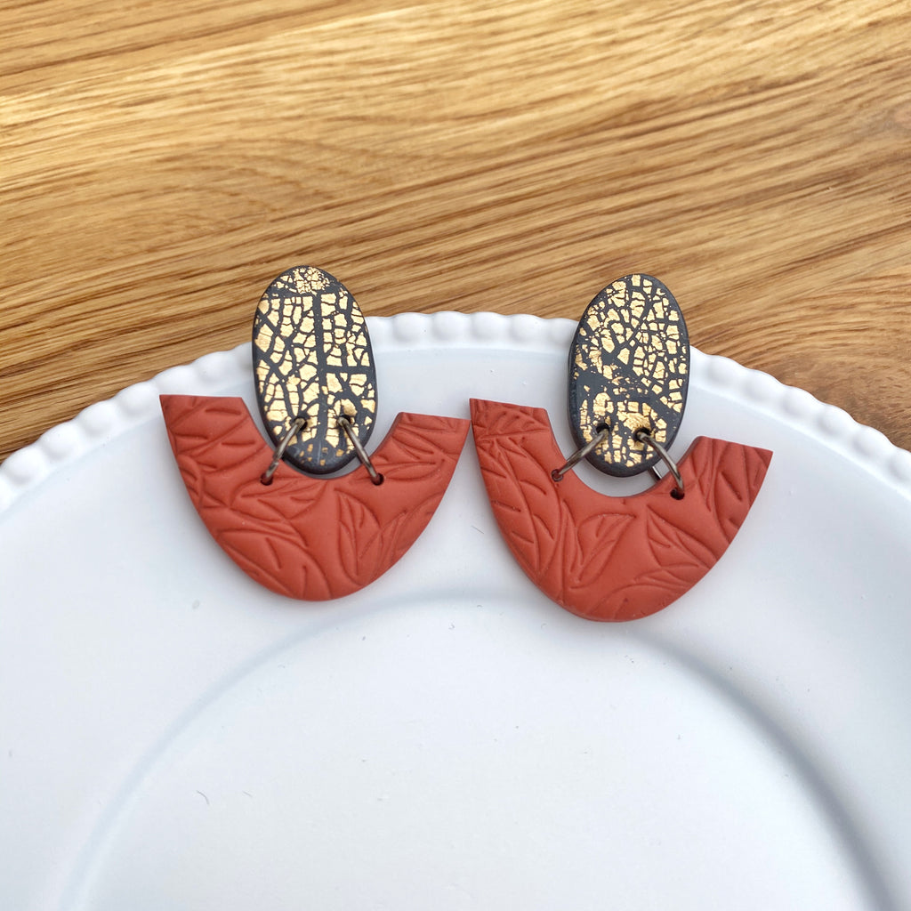Oval and half donut burnt orange with gold statement earrings