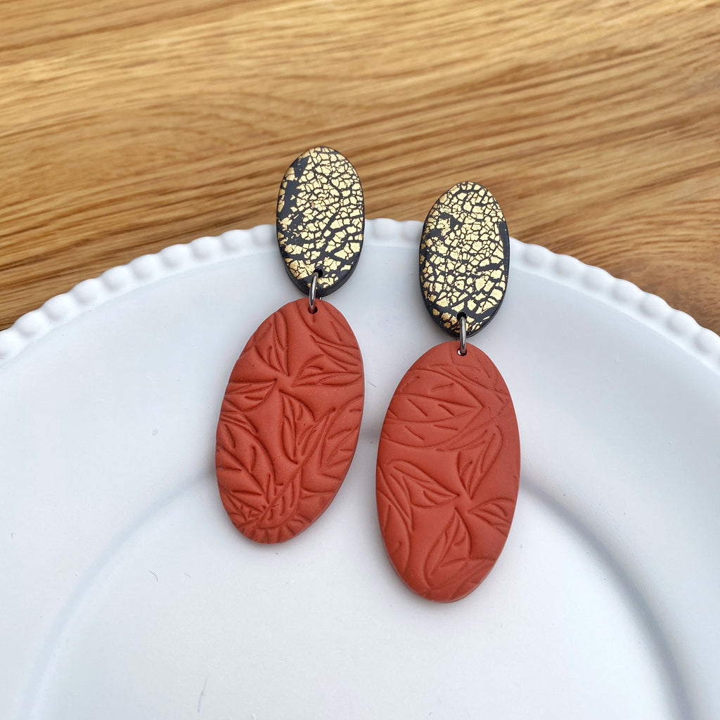 Double oval in burnt orange and golf statement earrings